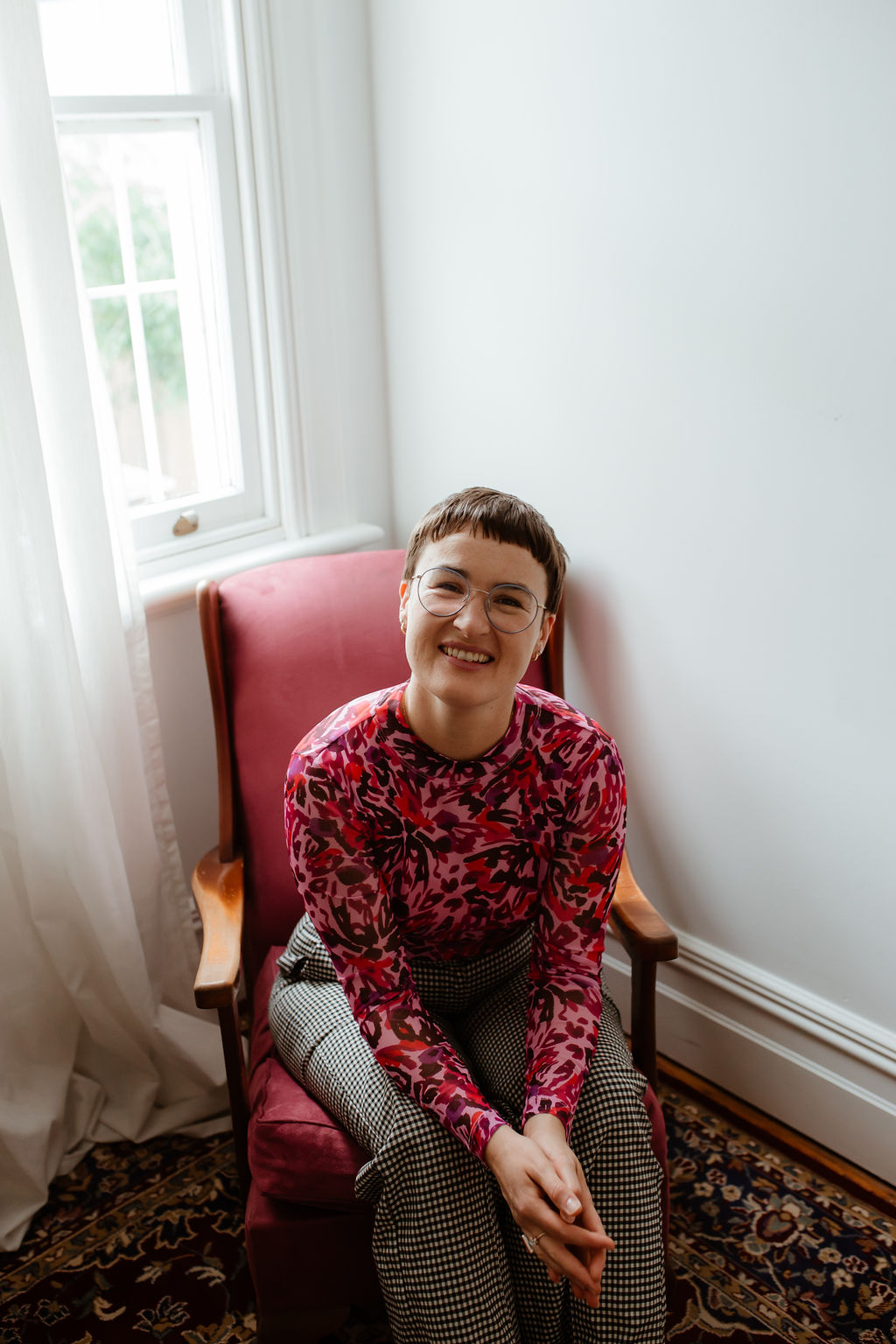 Chauncey Sjostedt seated in her therapy room in Surry Hills — warm, approachable Gestalt therapist